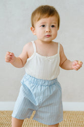 Baby wearing Avauma pure vanilla sleeveless top and blue striped shorts – fresh summer outfit